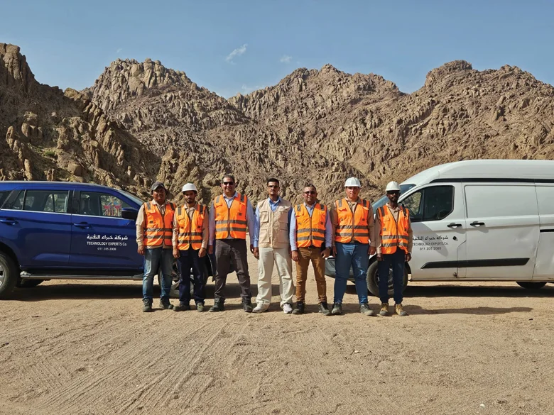 Field team sampling mountainous terrain for the medical-geology project