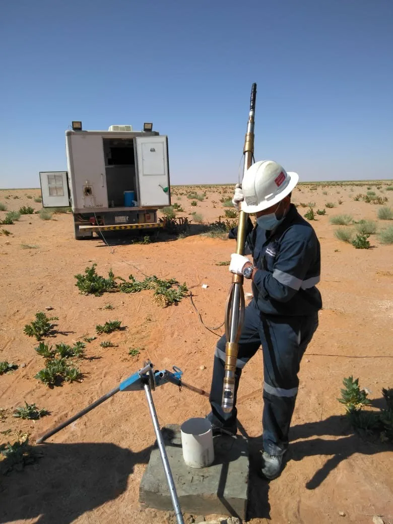 Technician operating a geophysical well-logging winch