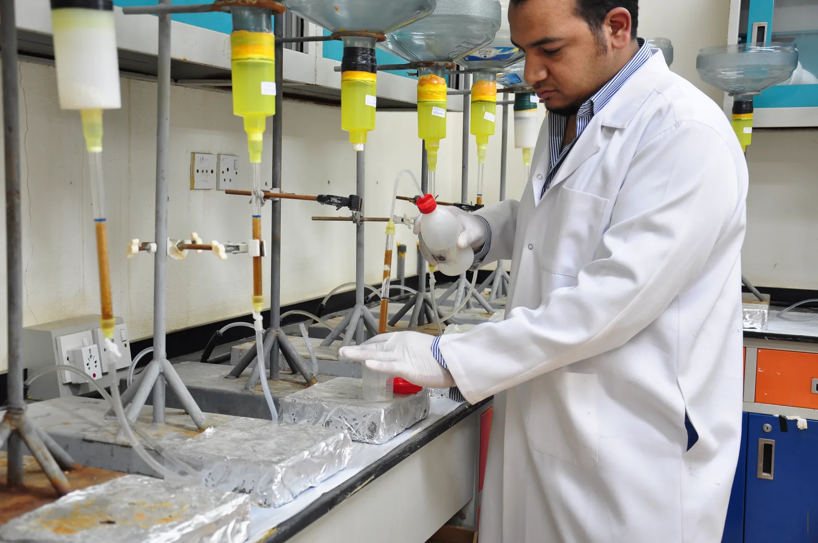Analyst running a liquid-liquid extraction on separatory funnels