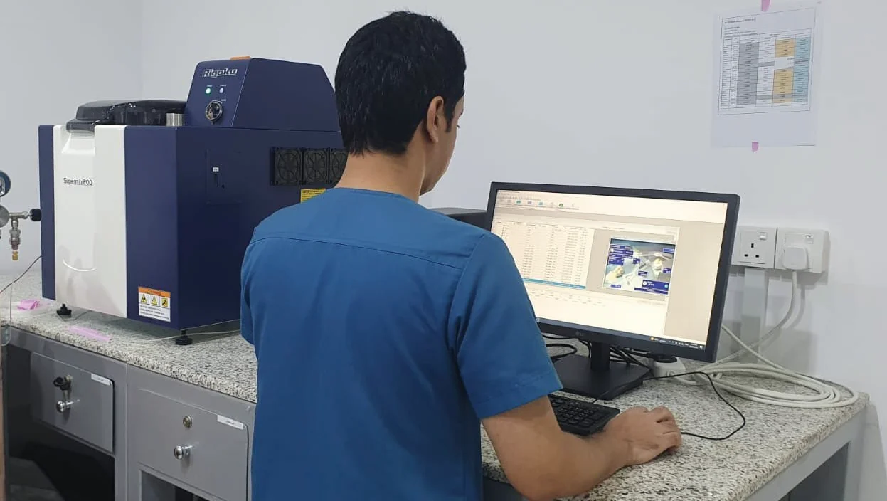Analyst running samples on a spectrometry system in the accredited laboratory
