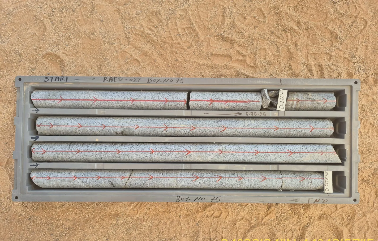 Recovered drill core in a core tray