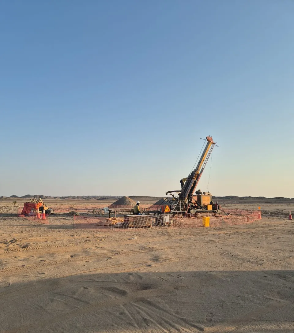 Drill rig operating at dusk