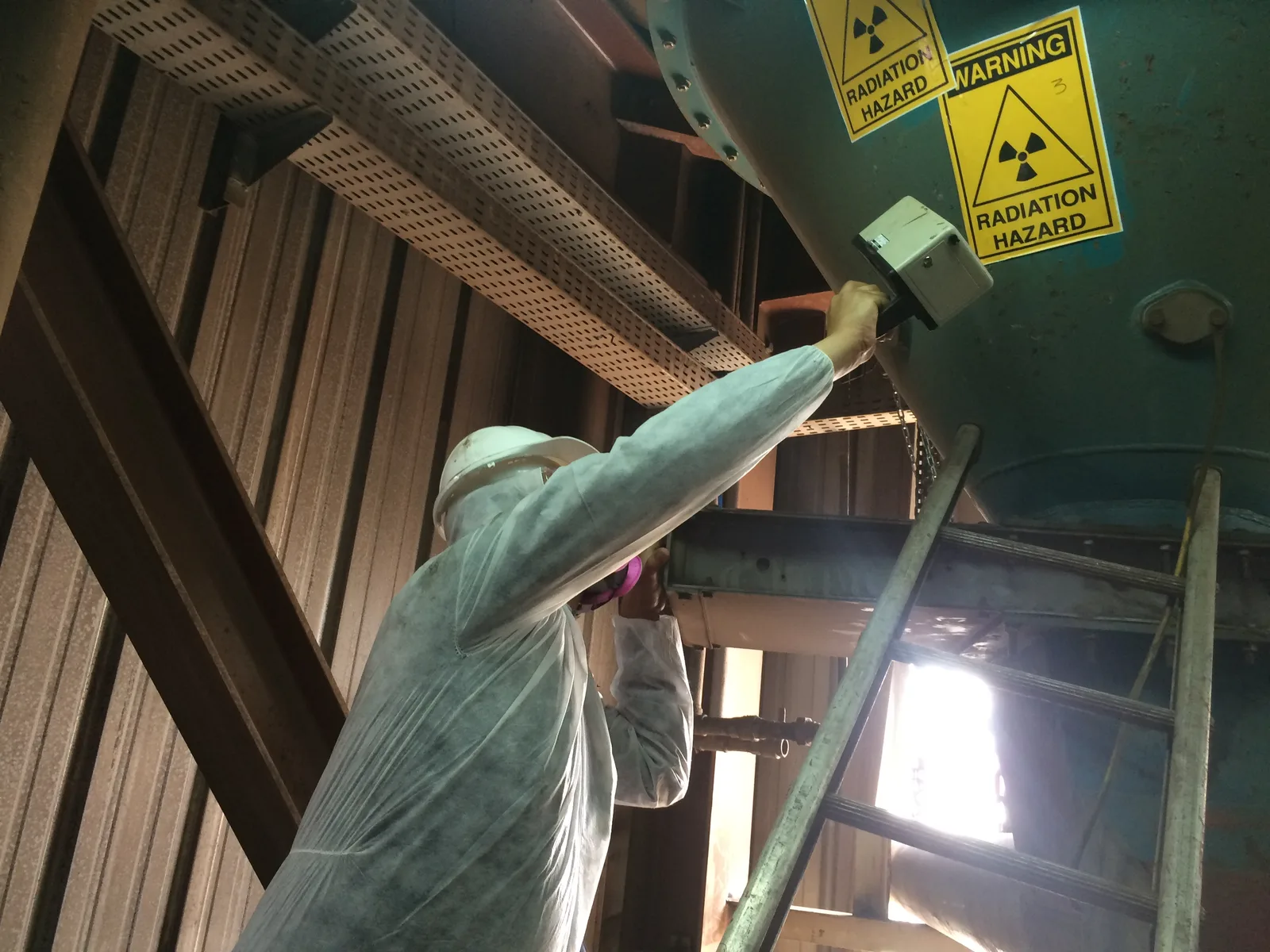 Technician working at a sealed-source housing
