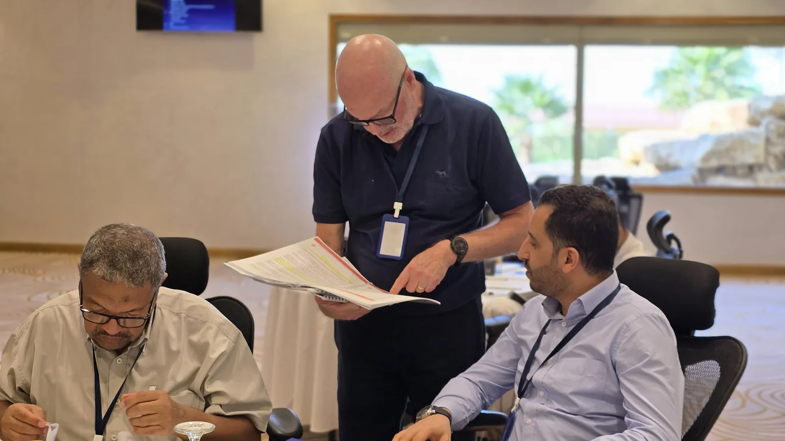 Instructor reviewing coursework with trainees